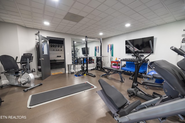 workout area featuring a drop ceiling