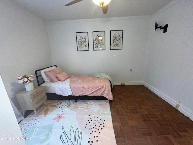 bedroom with ceiling fan and dark parquet floors