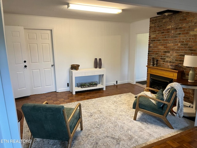 living room featuring dark parquet floors, a large fireplace, and brick wall