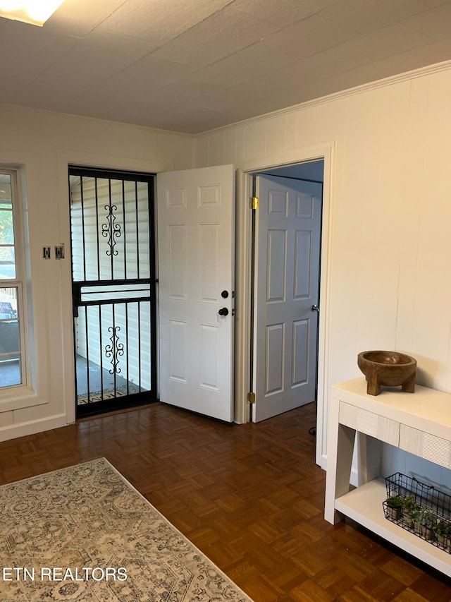 entrance foyer featuring dark parquet floors