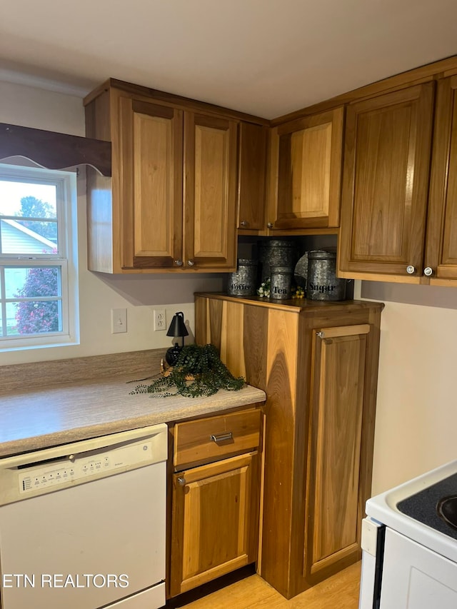 kitchen featuring light hardwood / wood-style floors and white appliances