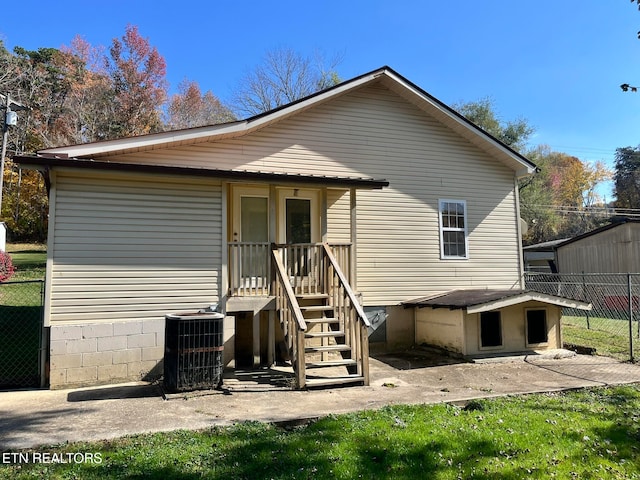 rear view of property featuring central AC