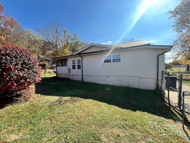 view of home's exterior with a lawn