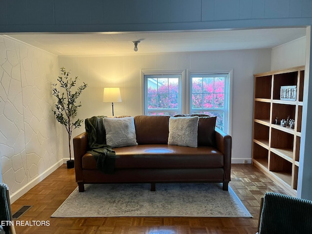 living room featuring dark parquet flooring