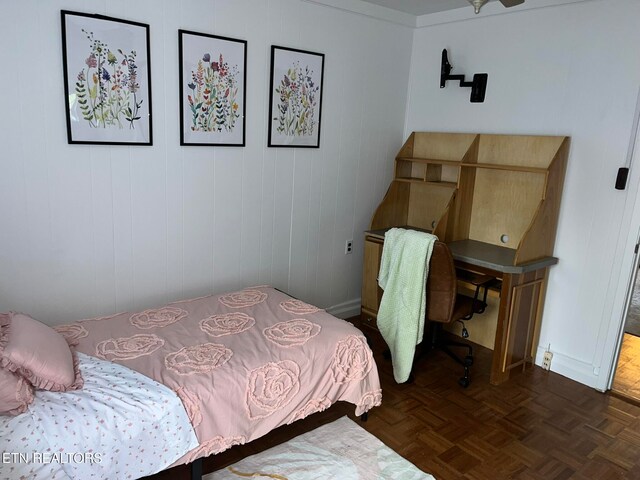 bedroom with dark parquet floors