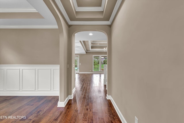 hall with ornamental molding, a tray ceiling, and dark hardwood / wood-style floors