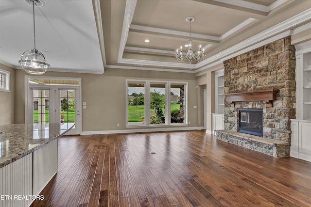 unfurnished living room featuring dark hardwood / wood-style flooring, crown molding, a fireplace, and plenty of natural light