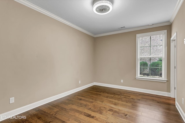 empty room with ornamental molding and hardwood / wood-style flooring