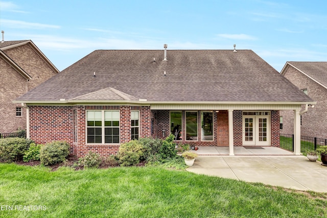 rear view of house featuring a patio area and a yard