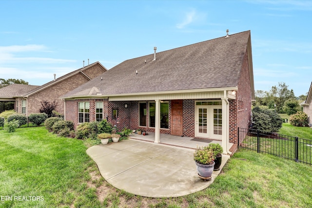 back of property featuring a yard and a patio area