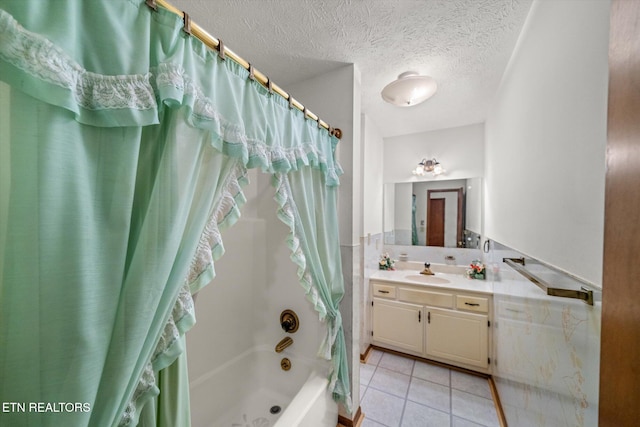 bathroom featuring vanity, shower / bath combo with shower curtain, a textured ceiling, and tile patterned floors