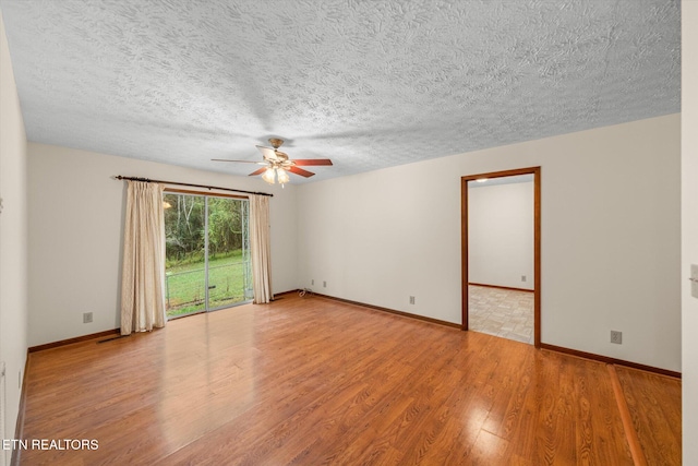 spare room featuring hardwood / wood-style floors, a textured ceiling, and ceiling fan