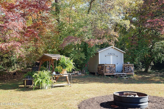 view of yard with a storage unit and a fire pit