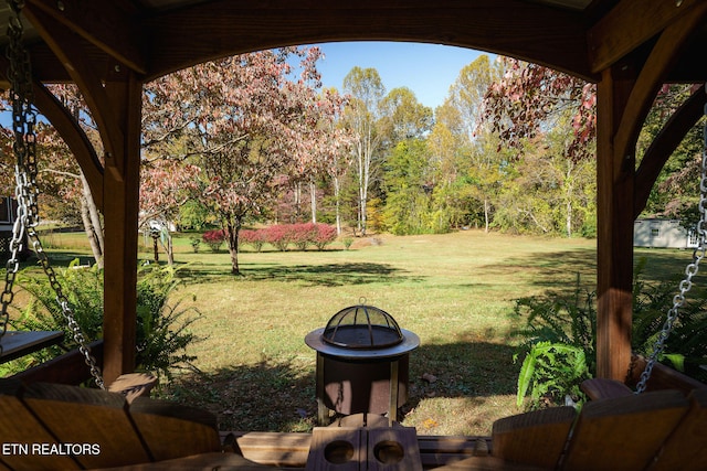 view of yard with a fire pit