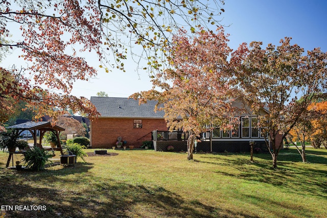 view of yard with a wooden deck, a gazebo, and an outdoor fire pit