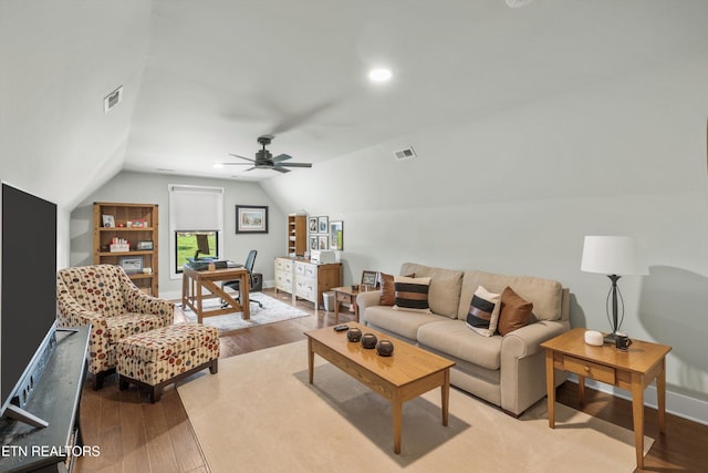 living room featuring ceiling fan, light hardwood / wood-style floors, and vaulted ceiling