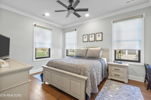 bedroom featuring ceiling fan, dark wood-type flooring, and ornamental molding