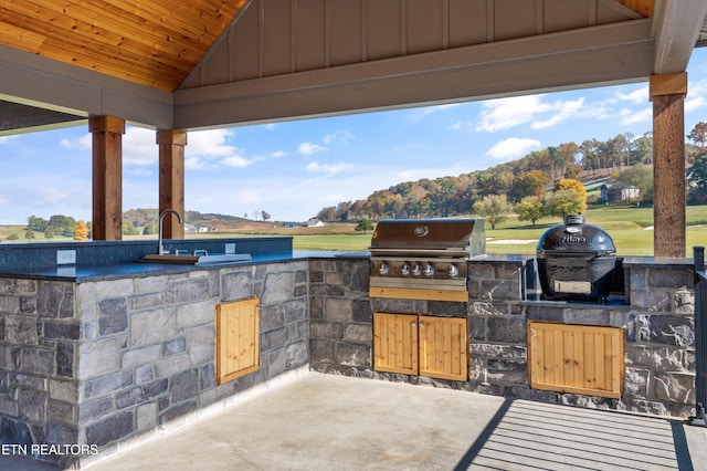 view of patio / terrace featuring grilling area, sink, and an outdoor kitchen