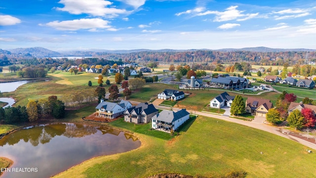 birds eye view of property with a water and mountain view