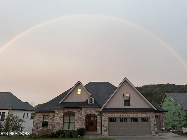 view of front of property with a garage and a lawn