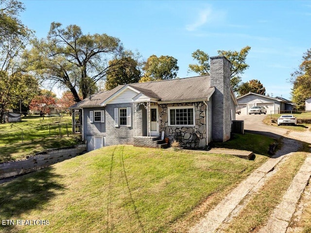 view of front facade with a front yard and central AC unit