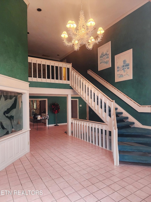 stairs with tile patterned flooring and a notable chandelier