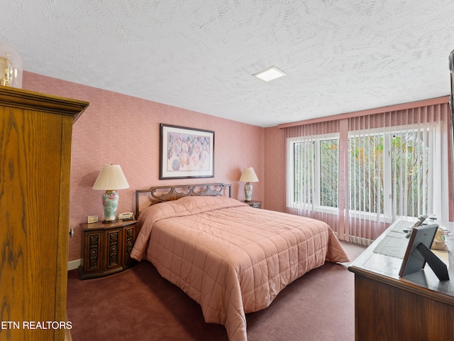 carpeted bedroom featuring a textured ceiling