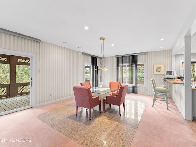 carpeted dining room with french doors