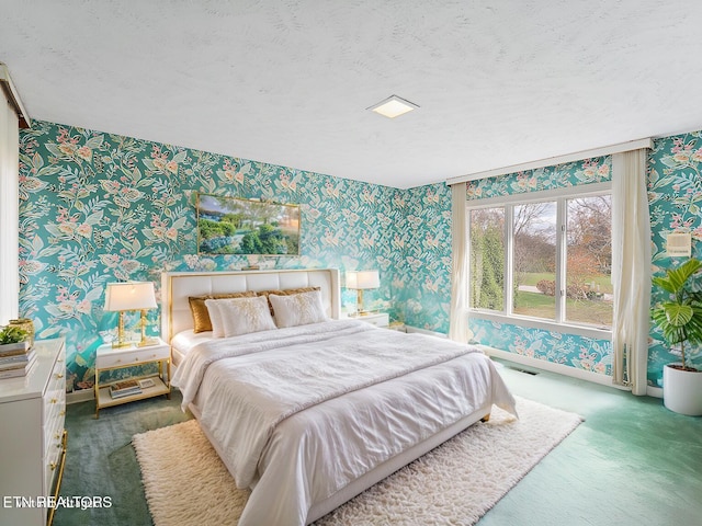 carpeted bedroom featuring a textured ceiling