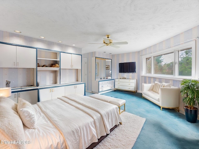 bedroom with carpet flooring, a textured ceiling, and ceiling fan