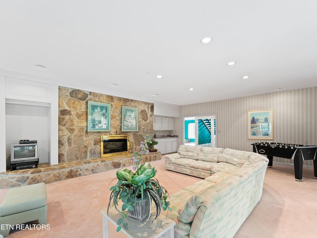 living room with a fireplace and light carpet