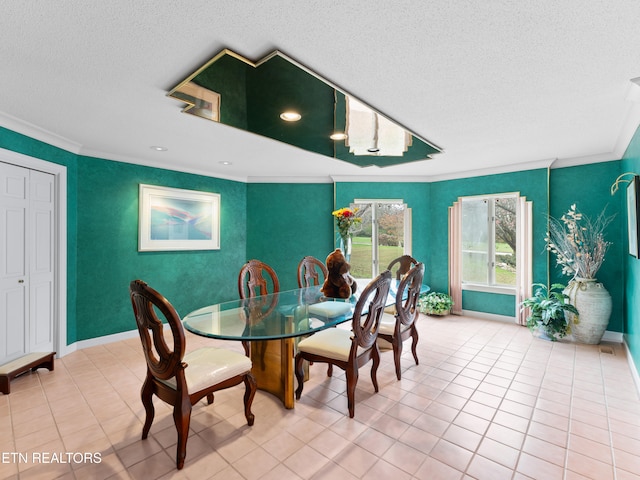 tiled dining room featuring a textured ceiling and ornamental molding