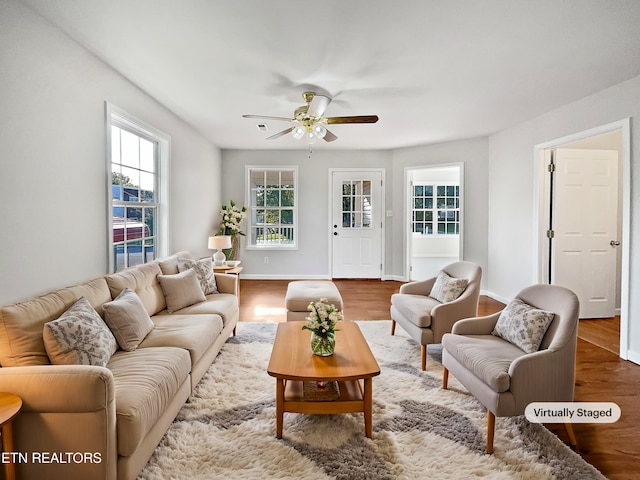 living room with ceiling fan and wood-type flooring