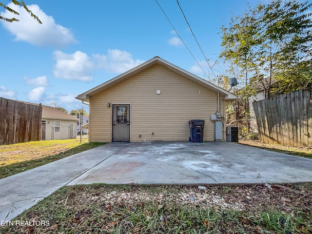 back of house with central AC