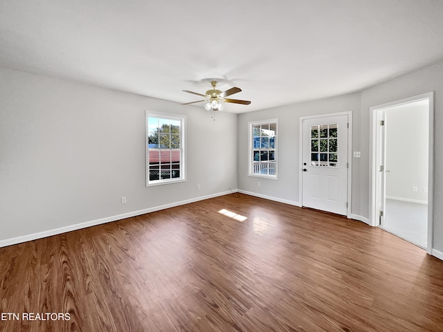 unfurnished room with ceiling fan and dark hardwood / wood-style flooring