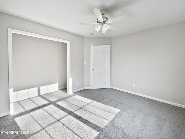 carpeted empty room with ceiling fan