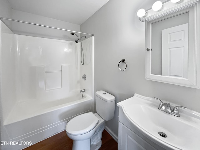 full bathroom featuring toilet, bathtub / shower combination, hardwood / wood-style floors, and vanity