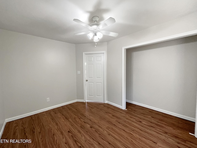 unfurnished bedroom with ceiling fan, a closet, and dark hardwood / wood-style flooring