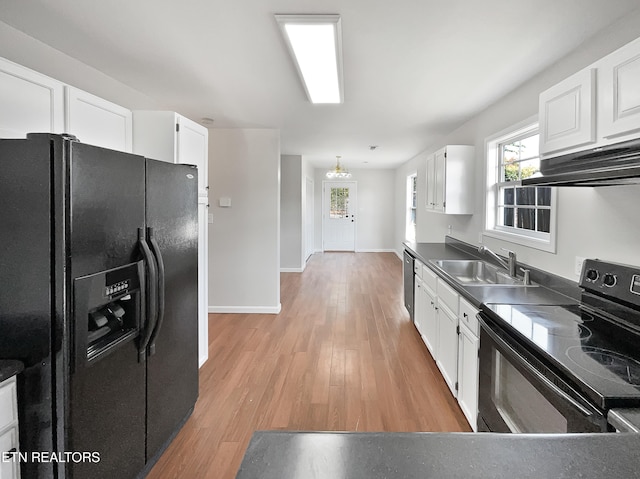 kitchen featuring white cabinetry, light hardwood / wood-style flooring, black appliances, and sink