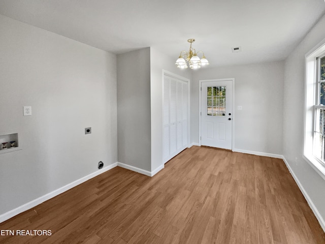 interior space with light hardwood / wood-style flooring and an inviting chandelier