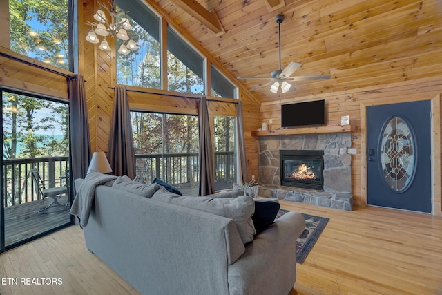 living room featuring a healthy amount of sunlight, high vaulted ceiling, and hardwood / wood-style floors