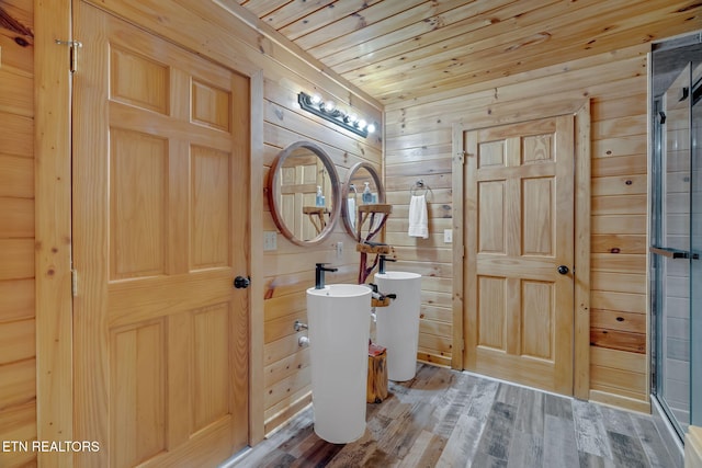 bathroom with walk in shower, wood ceiling, wood-type flooring, and wood walls