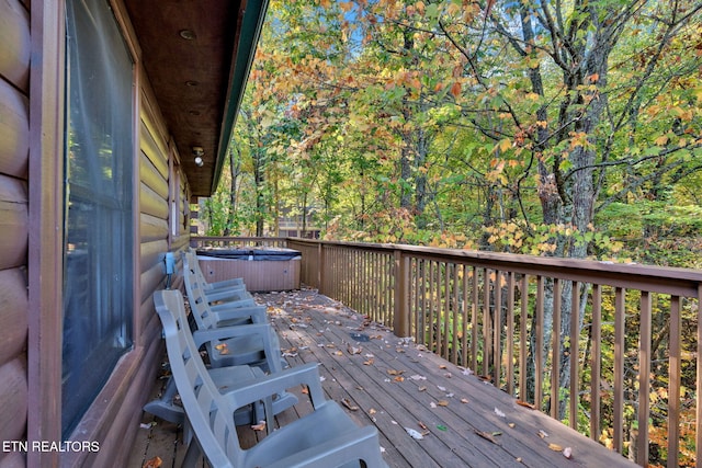 wooden terrace with a hot tub