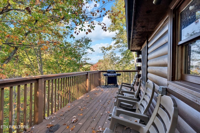 wooden terrace with area for grilling