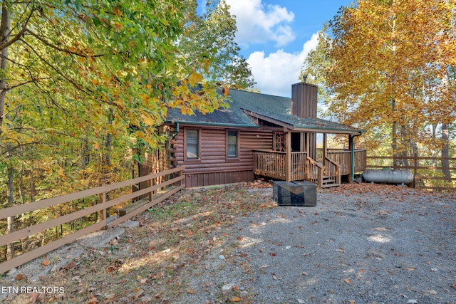 rear view of property with a wooden deck