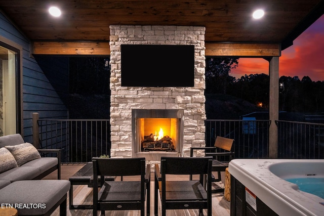 view of patio / terrace featuring an outdoor stone fireplace