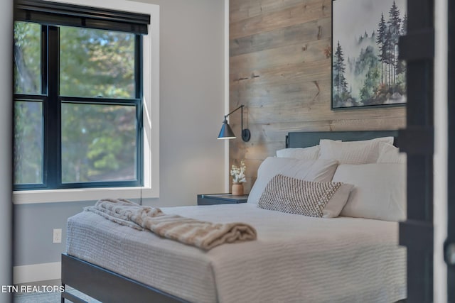 bedroom with wooden walls