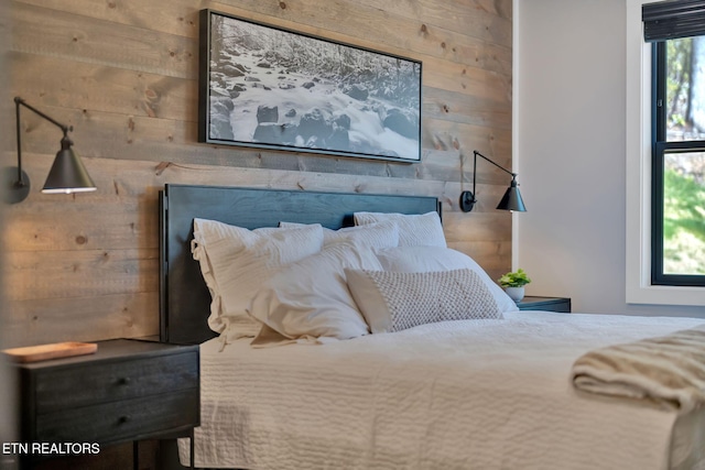 bedroom with wooden walls