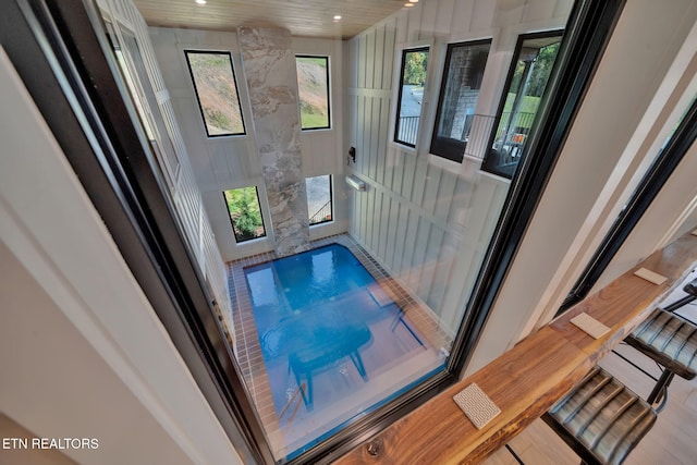 interior details featuring wood-type flooring and a pool