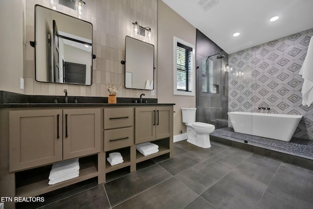 full bathroom with vanity, toilet, tile walls, and separate shower and tub